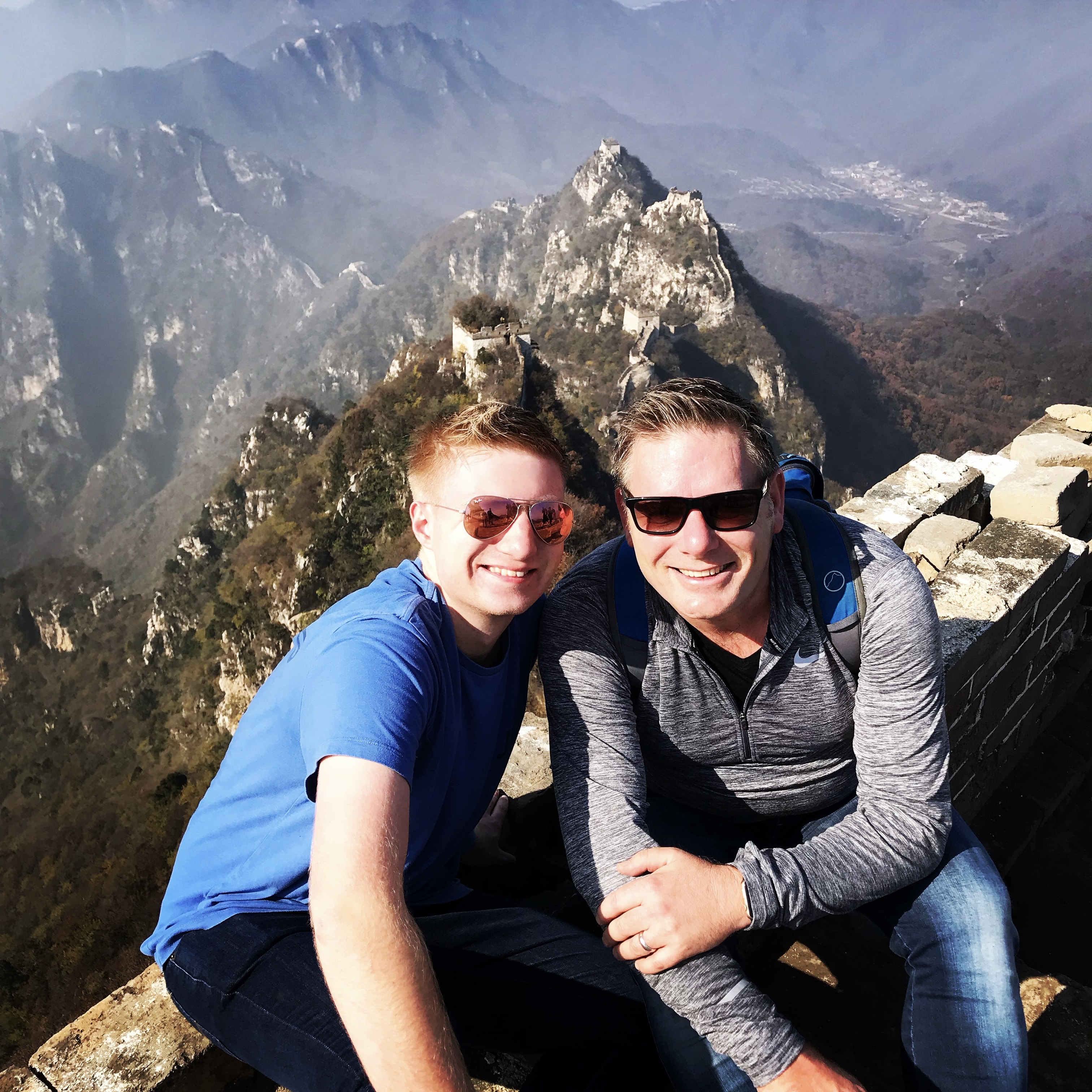 Sam with his father on the Great Wall of China, a treasured memory carried into his diving journey.