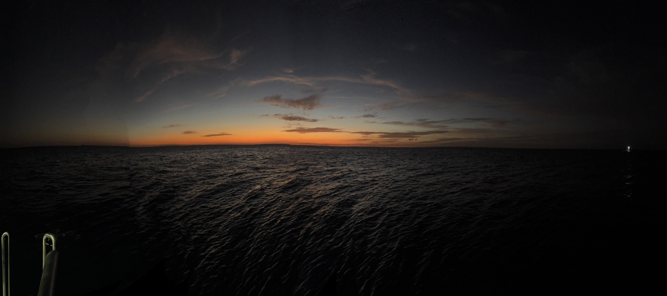 A sunset over dark Bahamian water from Dolphin Dream.