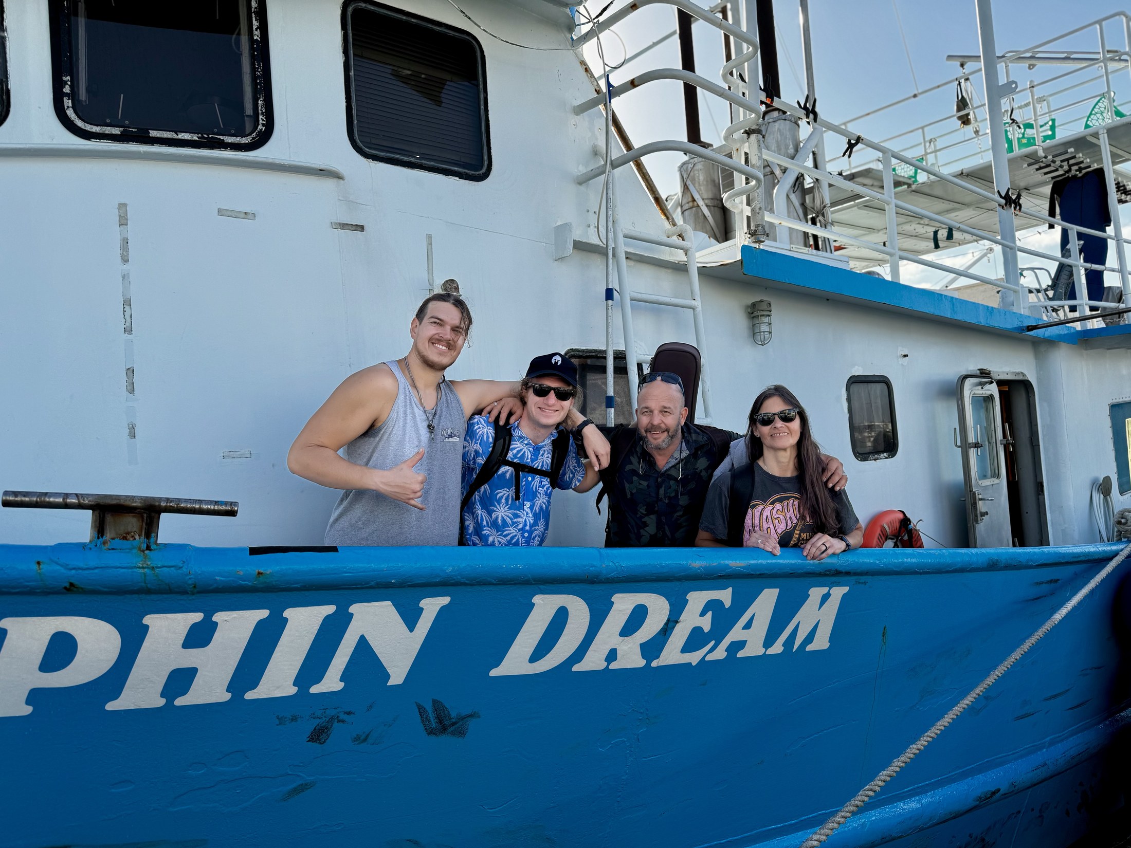 A group of divers and crew sharing time together aboard a liveaboard.